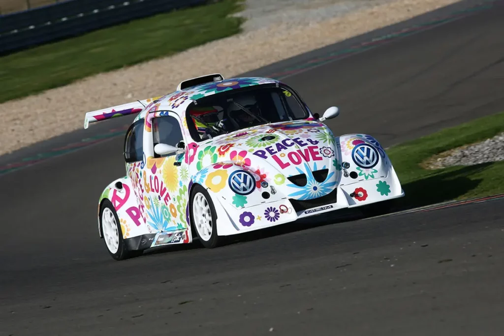 La VW Fun Cup décoration Peace and Love en pleine accélération sur la piste du circuit de Mettet.