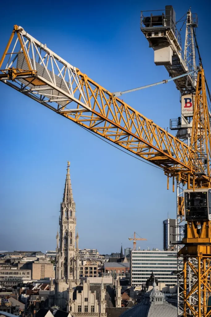 Vue verticale au téléobjectif depuis le rooftop 58 sur l'Hôtel de Ville de Bruxelles et une grue de chantier en premier plan